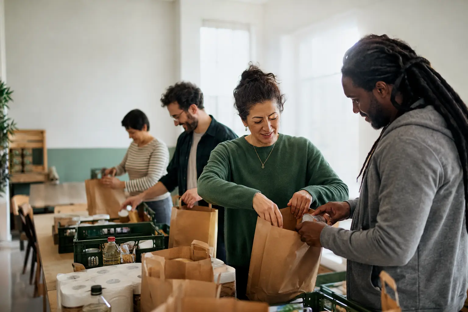Adults volunteering together to pack food and care supplies